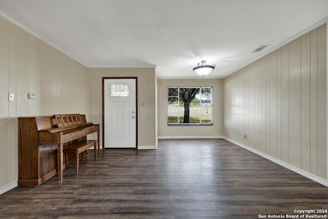 entryway featuring crown molding and dark wood-type flooring