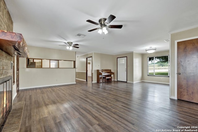 unfurnished living room with a fireplace, dark hardwood / wood-style flooring, and ceiling fan