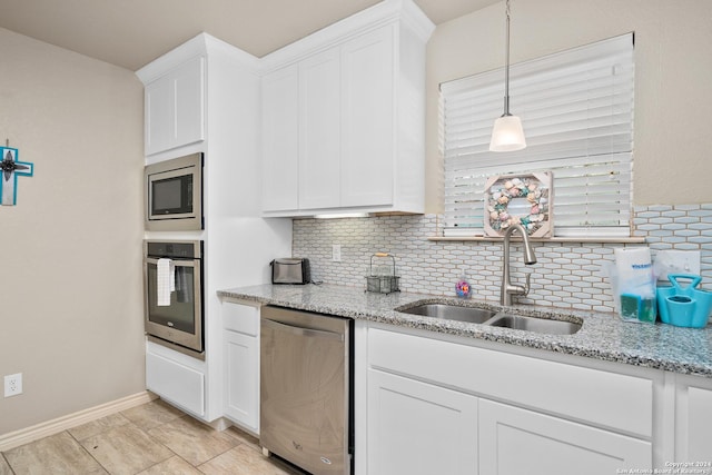 kitchen featuring sink, white cabinetry, stainless steel appliances, and tasteful backsplash