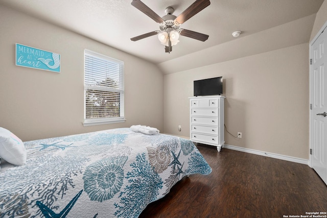 bedroom with ceiling fan, dark hardwood / wood-style flooring, and vaulted ceiling