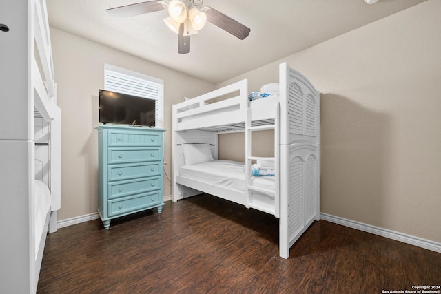 unfurnished bedroom with ceiling fan and dark wood-type flooring