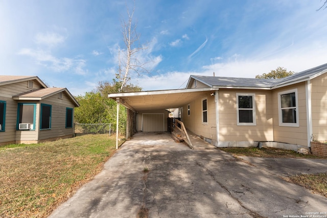 view of side of property with a yard and a carport