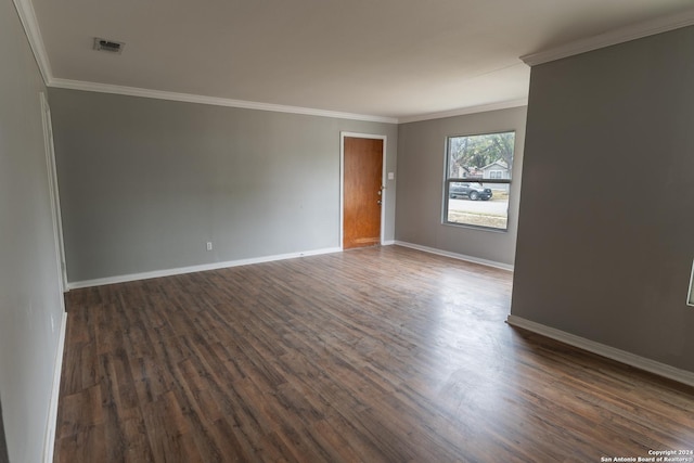 unfurnished room with crown molding and dark wood-type flooring