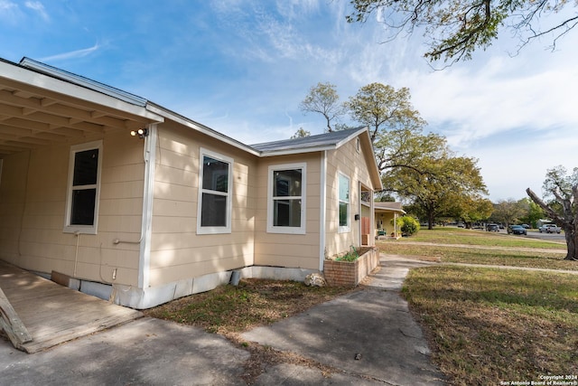 view of property exterior with a lawn