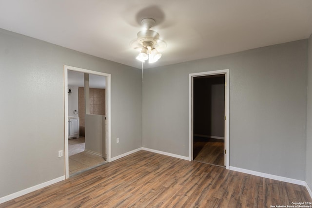 empty room featuring ceiling fan and dark wood-type flooring