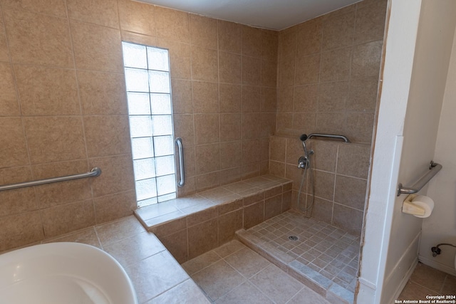 bathroom featuring tile patterned floors and independent shower and bath