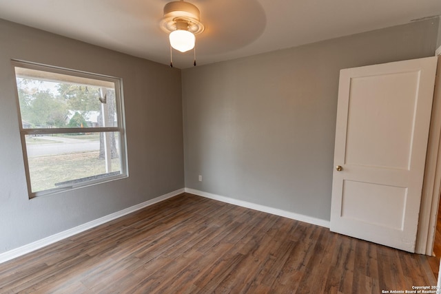 unfurnished room featuring ceiling fan and dark wood-type flooring