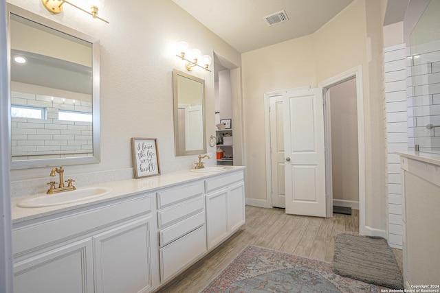 bathroom with hardwood / wood-style floors and vanity