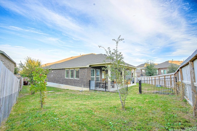 back of house with a lawn