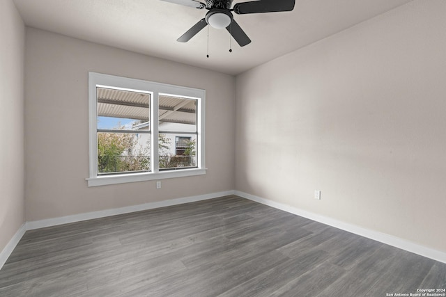 spare room with ceiling fan and dark hardwood / wood-style floors