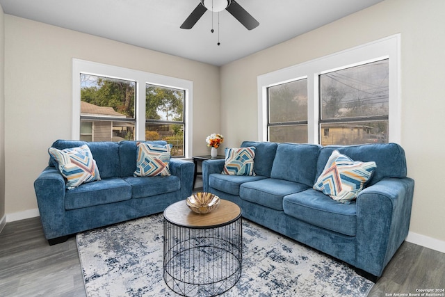 living room with dark hardwood / wood-style floors and ceiling fan