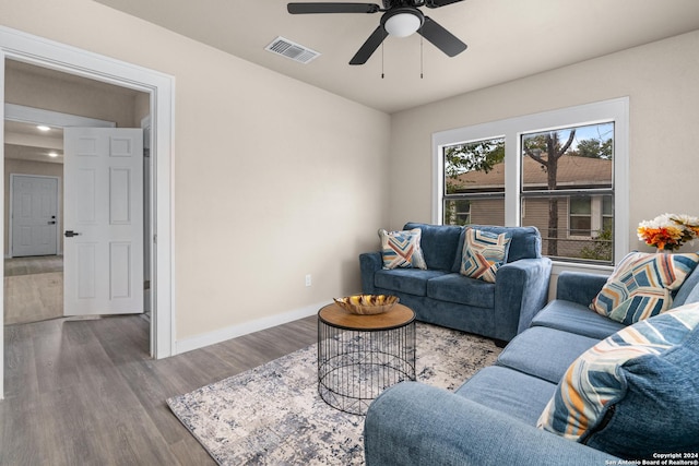 living room with ceiling fan and light hardwood / wood-style floors