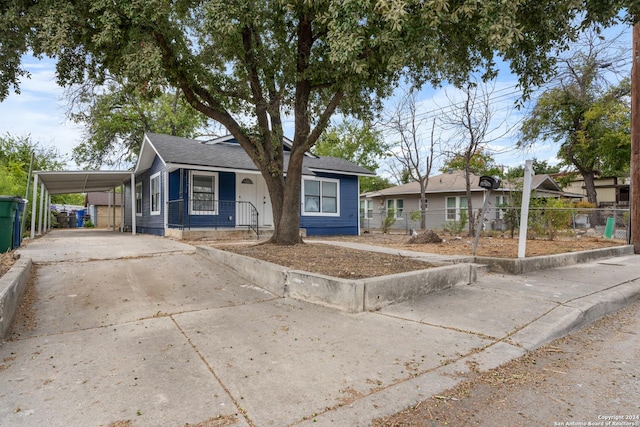 single story home featuring a carport