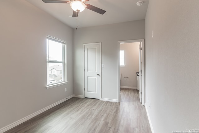 unfurnished bedroom with ceiling fan and light hardwood / wood-style floors