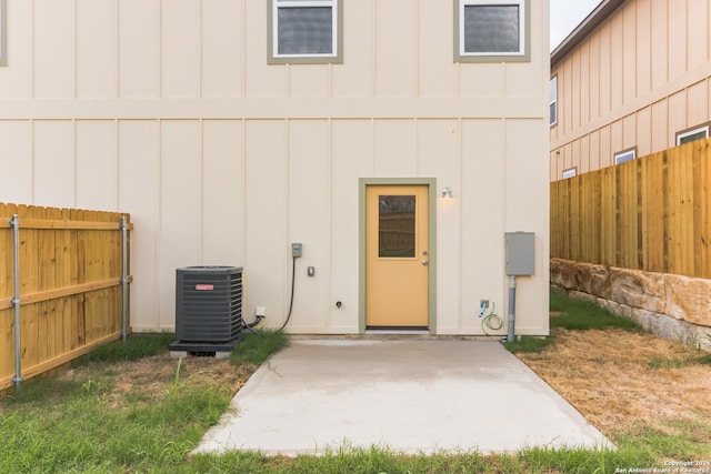 entrance to property with a patio and central AC