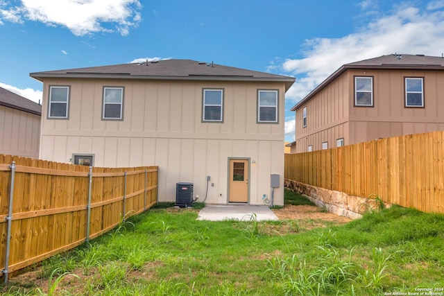 rear view of house with a patio area and central AC unit