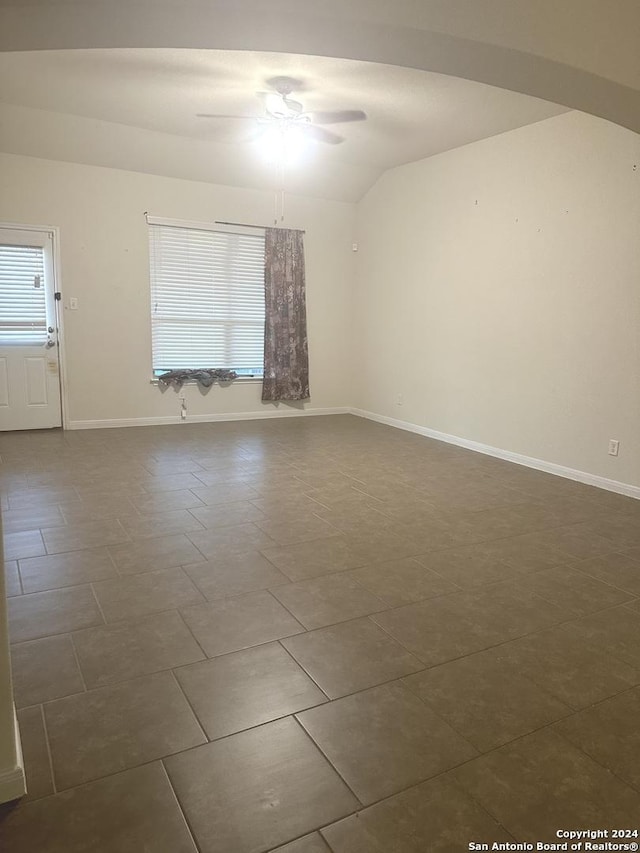 spare room featuring ceiling fan and lofted ceiling