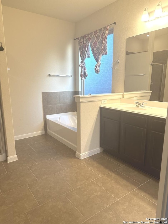 bathroom with vanity, tile patterned flooring, and plus walk in shower