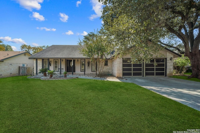 view of front facade featuring a front lawn, a porch, and a garage