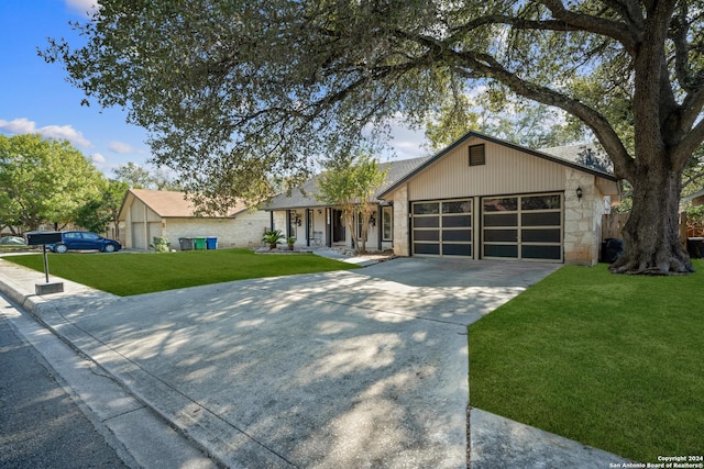 ranch-style house featuring covered porch, a garage, and a front lawn