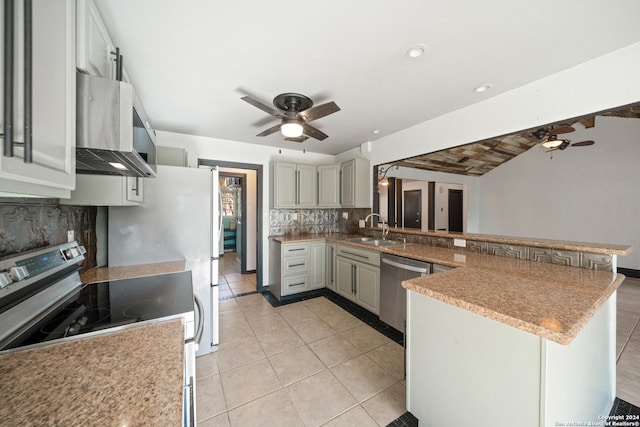 kitchen featuring kitchen peninsula, sink, wall chimney exhaust hood, and appliances with stainless steel finishes