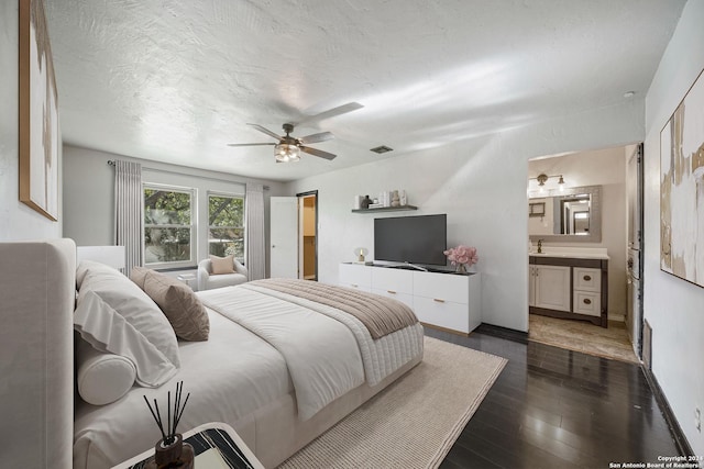 bedroom featuring ensuite bath, ceiling fan, and dark hardwood / wood-style floors