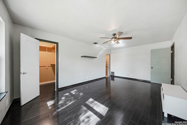 spare room with dark hardwood / wood-style floors and ceiling fan