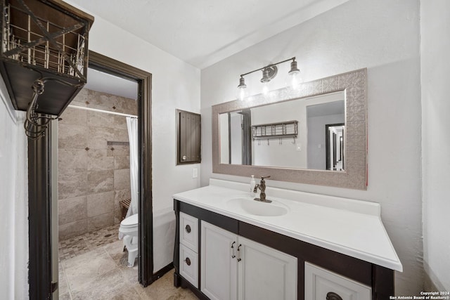 bathroom featuring walk in shower, vanity, and toilet