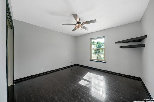 empty room featuring ceiling fan and dark hardwood / wood-style flooring