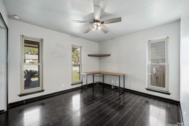 spare room featuring dark hardwood / wood-style flooring and ceiling fan