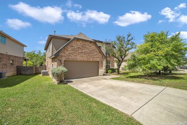 view of front of property featuring central AC unit, a garage, and a front lawn