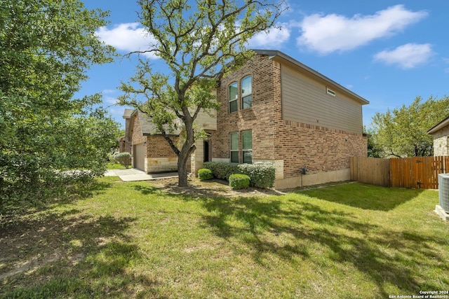 view of home's exterior featuring a garage and a lawn