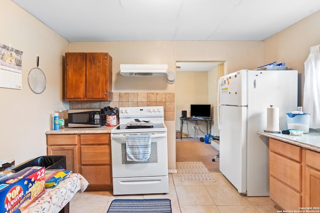 kitchen featuring white appliances, tasteful backsplash, and light tile patterned flooring