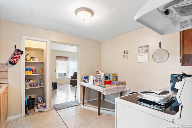 clothes washing area featuring light tile patterned flooring and washer / clothes dryer