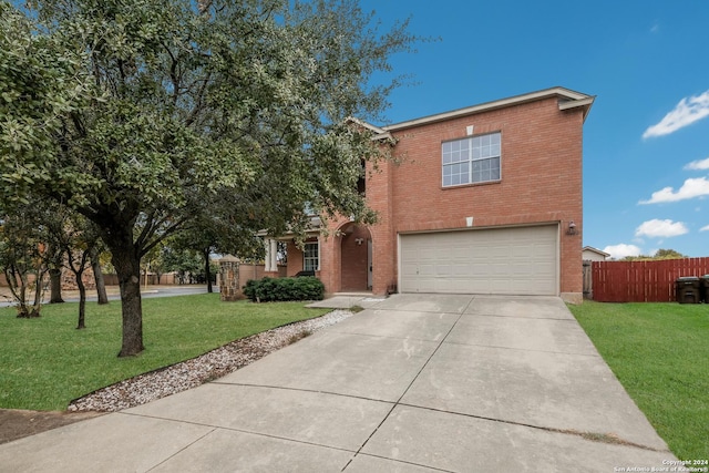 view of front of property featuring a garage and a front lawn