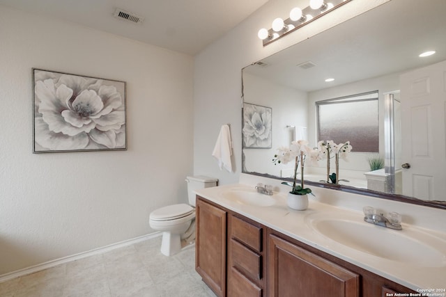 bathroom with tile patterned flooring, vanity, toilet, and walk in shower