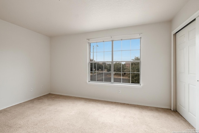 unfurnished bedroom with carpet flooring and a closet