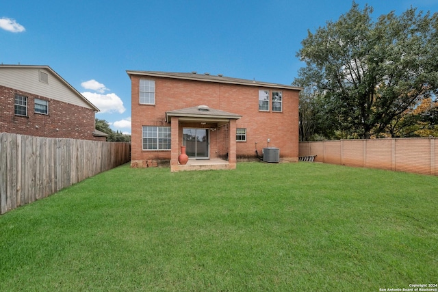 back of property featuring a patio, central AC unit, and a lawn