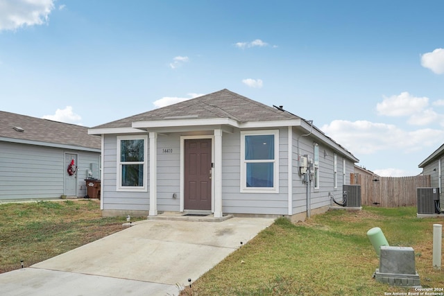 bungalow featuring central AC and a front lawn