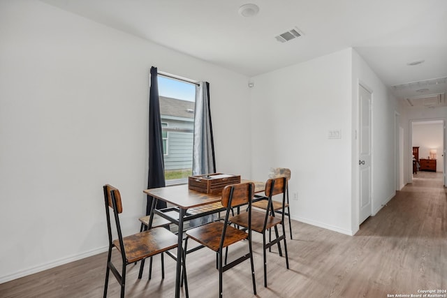 dining room with a healthy amount of sunlight and light wood-type flooring