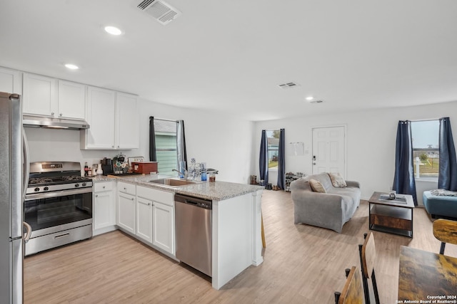 kitchen with kitchen peninsula, appliances with stainless steel finishes, light hardwood / wood-style floors, and white cabinetry