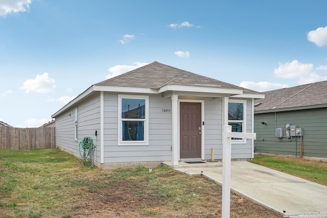 bungalow-style home with a front lawn