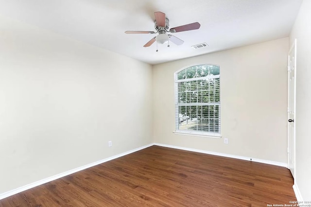 empty room featuring ceiling fan and dark hardwood / wood-style flooring