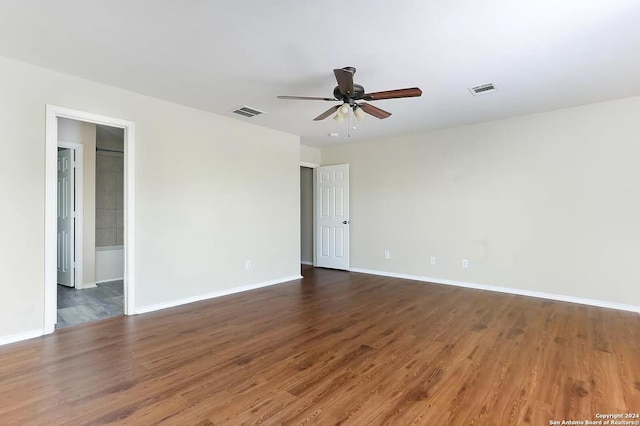 unfurnished room with ceiling fan and dark wood-type flooring