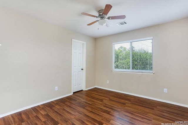 spare room with ceiling fan and dark wood-type flooring