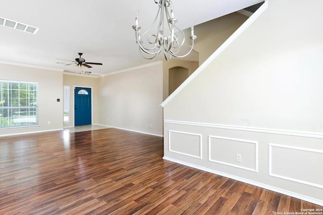 interior space featuring ceiling fan with notable chandelier, dark hardwood / wood-style flooring, and ornamental molding