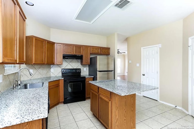 kitchen featuring stainless steel fridge, extractor fan, sink, electric range, and a kitchen island