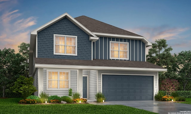 view of front of home featuring a yard and a garage