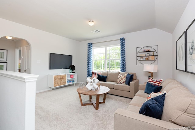 carpeted living room with vaulted ceiling