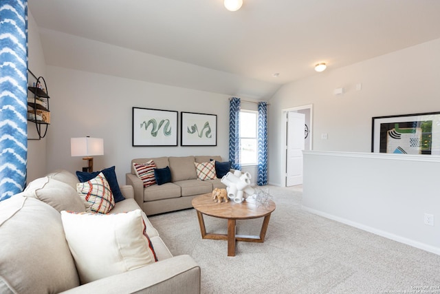 carpeted living room featuring vaulted ceiling